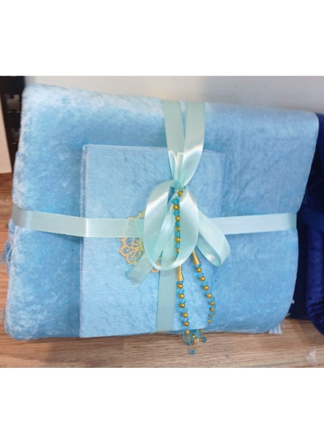 A box of a rug, a Qur’an, and a rosary
